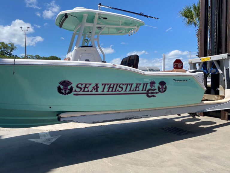Professional marine graphics installation adding style to boat exterior surfaces