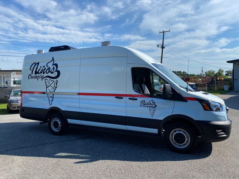 A white cargo van wrapped with the Nino's Creamery ice cream cone logo and a red stripe.