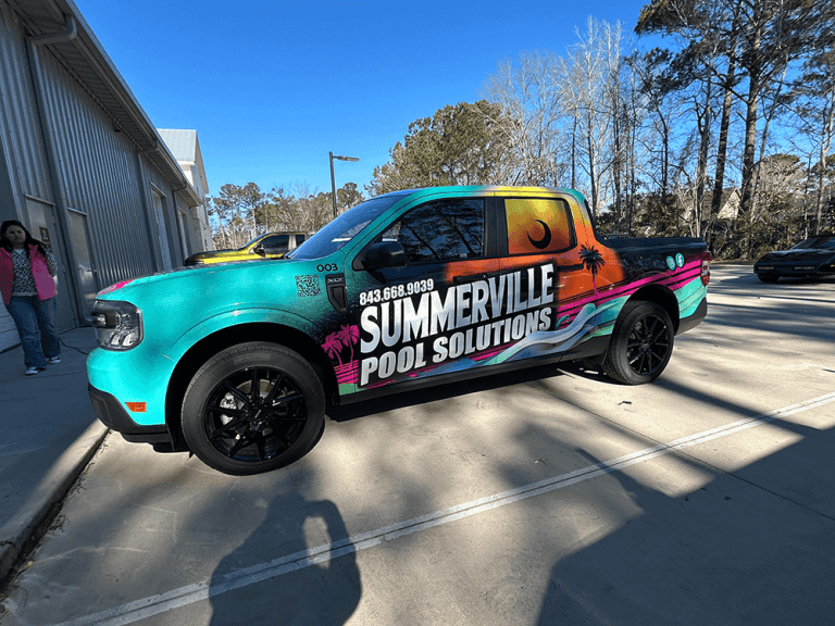 A teal, pink, and orange sunset-themed wrap covers a pickup truck for Summerville Pool Solutions.