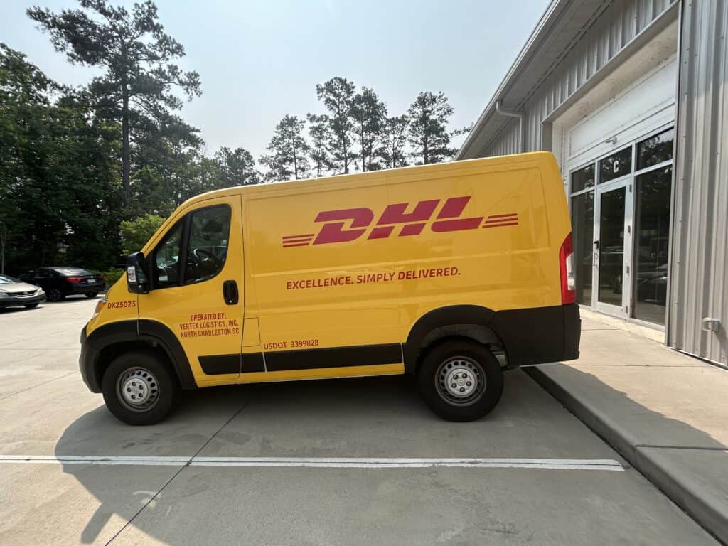 DHL delivery van with vibrant yellow wrap in Charleston, showcasing professional vehicle branding.