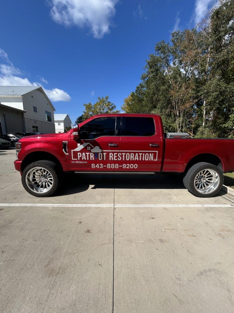 Patr of Restoration truck with custom red vehicle wrap in Charleston.