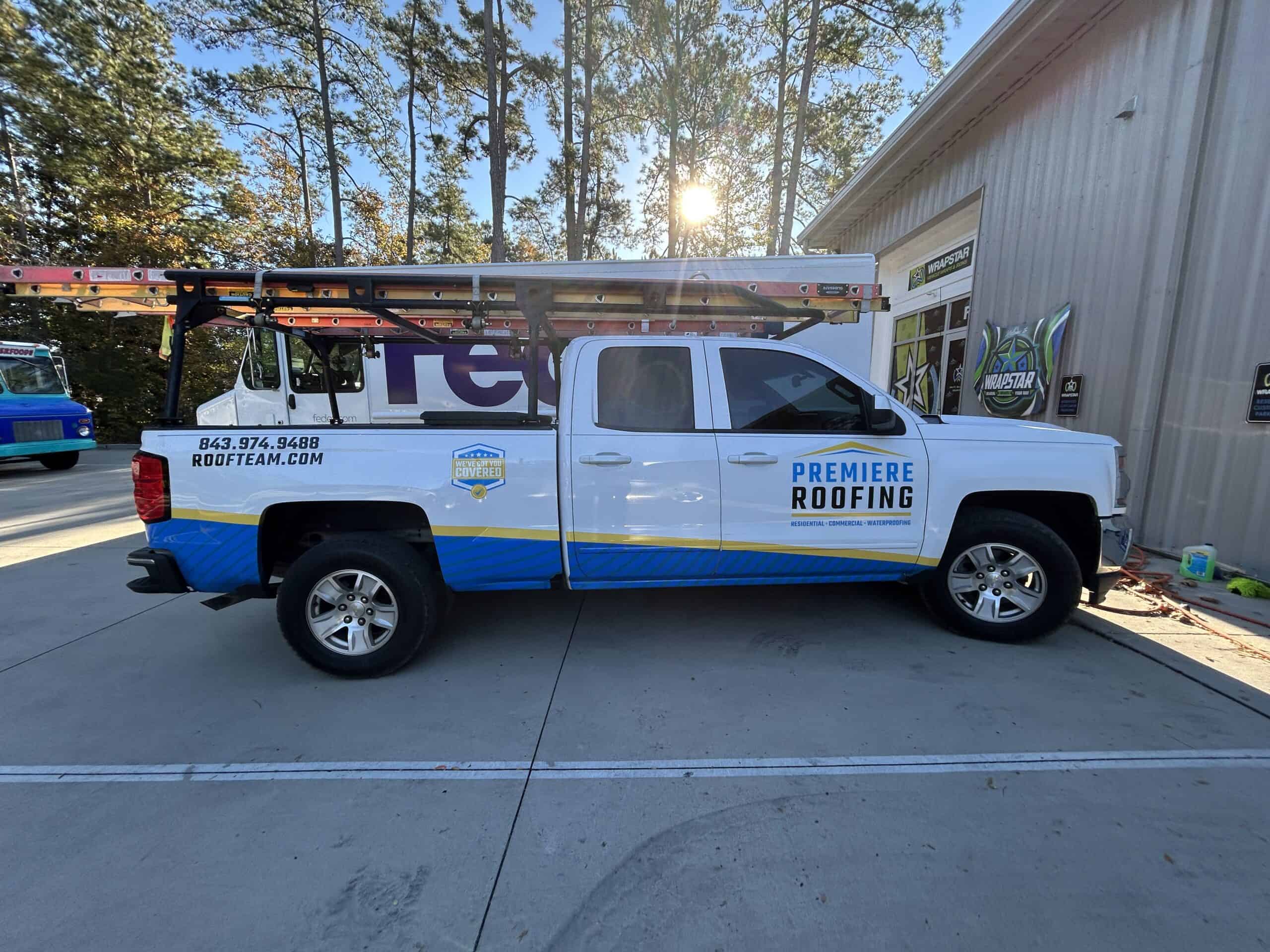 Commercial vehicle wrap showcasing roofing business branding and contact details.