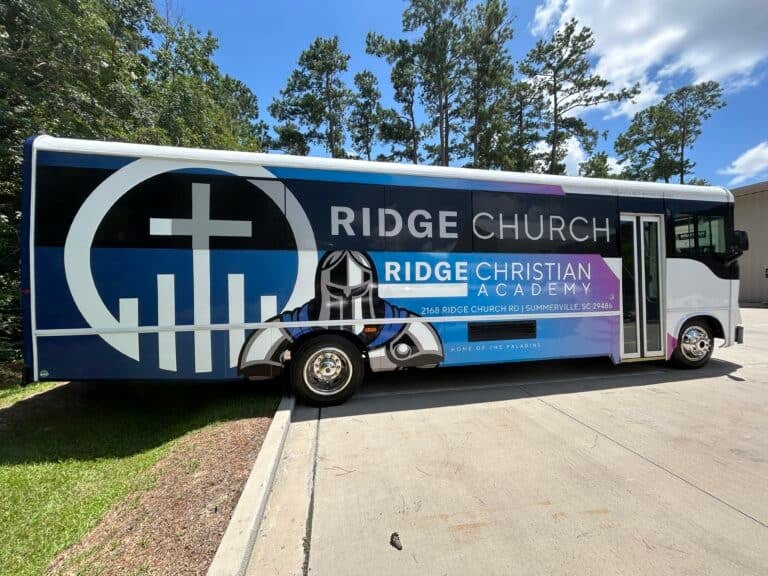 Custom church bus wrap with Ridge Church and Ridge Christian Academy branding in Charleston.